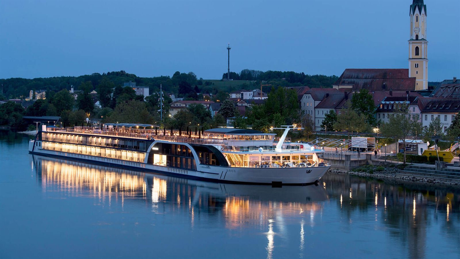 River cruise ship at a riverside town at dusk